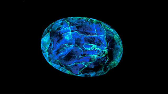 Fluorescent epoxy filling in emerald gemstone 