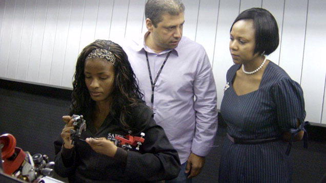 Managing director Rutang Moses confers with her factory manager and a diamond polisher