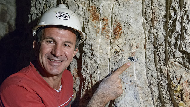 Miner points at black opal