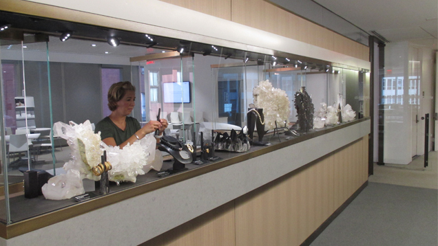 McKenzie Santimer is setting up the display in the long, narrow case.