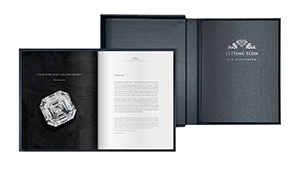 Monograph hard cover book open with diamond images and hard cover slip case, GIA report enclosed.