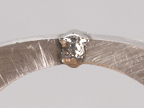 Platinum ring shank joint, overfilled with platinum cobalt after laser welding. 