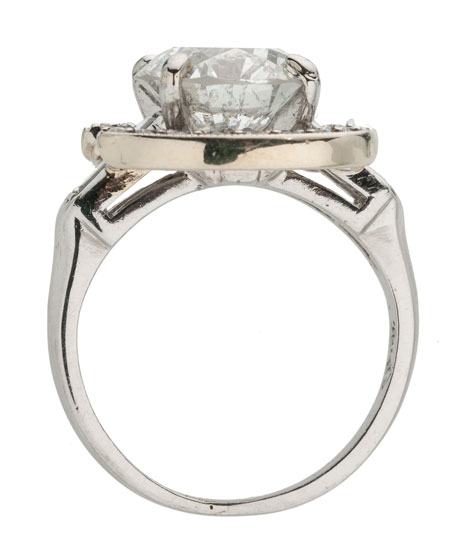 Side view of a platinum ring with a white gold and diamond halo surrounding the center stone