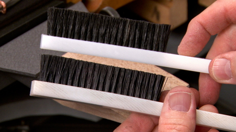 Two platinum work brushes; the top brush has natural bristles