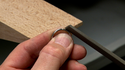 Filing a platinum ring with a file
