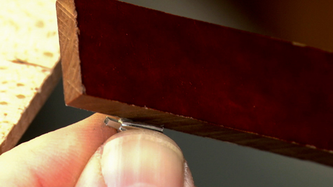 Abrasive stick prefinishing a platinum ring’s peg setting