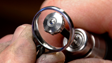 Rotary burnisher being used to smooth the inside of a platinum ring shank