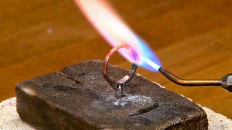 Alumina soldering block being used to solder a platinum solitaire ring
