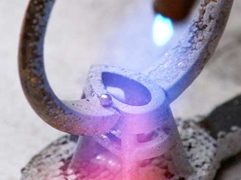 Platinum cobalt setting being soldered to 14K yellow gold shank