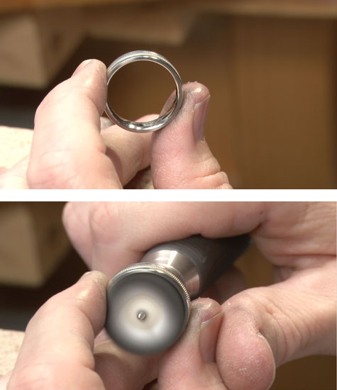 Jeweler holding a platinum band at the bench, in preparation for buffing