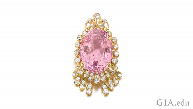 An oval pink sapphire framed by diamonds.