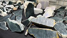 Figure 1. The rough Guatemalan jadeite jade sold by Yax Tun Minerals included blue, green, and lavender hues, with blue being the most prevalent. Photo by Tao Hsu; courtesy of Yax Tun Minerals.