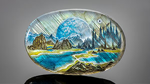 Left: A sci-fi scene in this oval measuring 48 &times; 72 &times; 8 mm and weighing 247 ct depicts streaks of light filtering through pine forests and reflecting in the lakes below. At the horizon, a giant moon emerges from behind the mountains. Photo by Robert Weldon. Right: Detail of variations in the perceived color, depending on the orientation of the light source. Photomicrograph by Nathan Renfro.