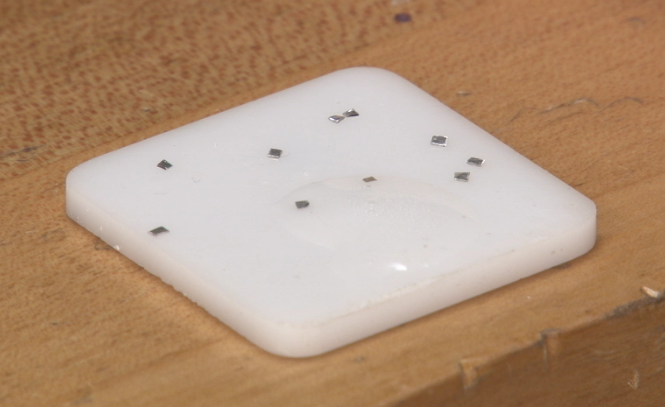 Ten pieces of platinum plumb solder on a solder plate