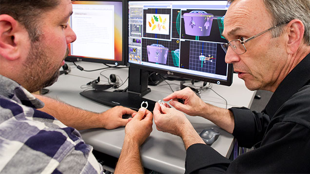 Student views prototype model of a ring 