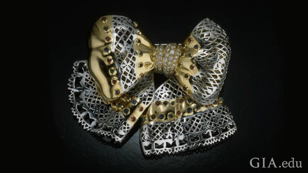 The bow section and ribbon tendrils are made from two metals – silver and gold colored. 