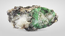 Figure 5. Two emerald specimens from quartz-calcite veins. A and B: Specimen containing emeralds and associated minerals such as white calcite, off-white quartz, and brown phlogopite. The calcite fluoresces moderately red (early crystallization, larger particles) and strongly blue (later filling crystallization, xenomorphic granular and smaller) under short-wave ultraviolet light. C: Emeralds with associated minerals such as white calcite, white or gray quartz, gray phenakite, and brown phlogopite. Photos by Sheng-Hao Zhu (A) and Yi Guo (B and C).