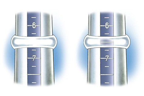 Close-up view of wide, tapered band positioned on plastic ring mandrel to check ring size