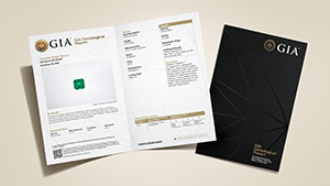 GIA Colored Stone Identification & Origin Report with main components of the report on display, and colored stones and pearls on the front cover.
