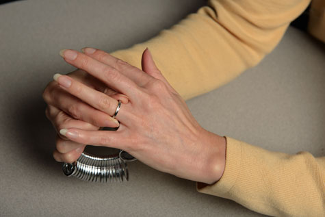 Close-up of customer using narrow finger sizing gauges to confirm accurate size