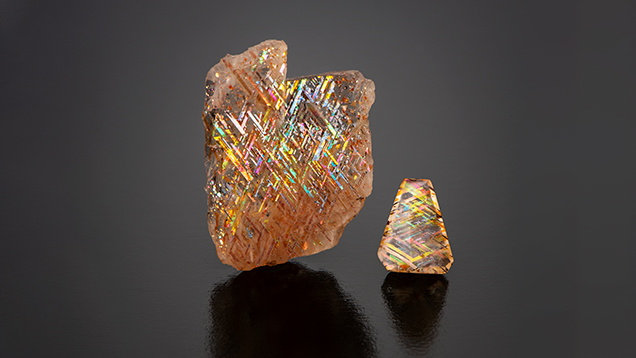 Courtesy of Rainbow Lattice, Australia<br>These two gems are rainbow lattice feldspar, weighing 20.74 carats and 2.18 carats. They feature distinctive lattice-like inclusions of magnetite or hematite, often accompanied by iridescent flashes of color known as aventurescence, making them prized for their rare and mesmerizing appearance. 