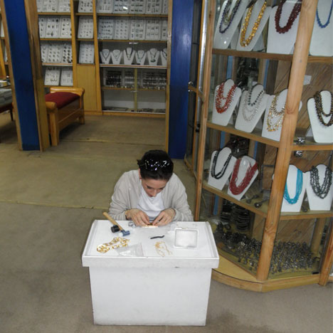Noëlle Vieillard-Jordi inspects loose colored stones during a visit to a dealer in India. Courtesy Bahina Jewels